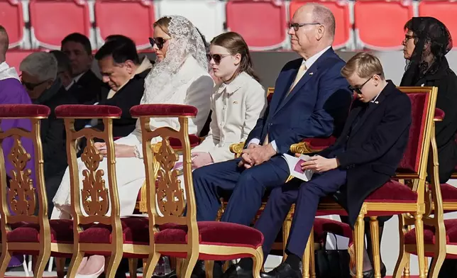 From left, Princess Charlen of Monaco , Crown Princess Gabriella, Prince Albert II of Monaco, and Prince Jacques attend a mass presided over by Pope Leo XIV at Stade Louis II in Fontvieille, Monaco, Saturday, March 28, 2026. (AP Photo/Laurent Cipriani)