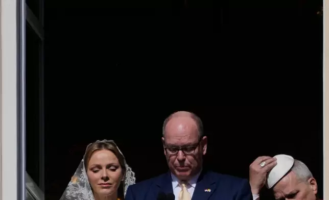 Pope Leo XIV, Princess Charlene of Monaco and Prince Albert II of Monaco appear at the Gallery of Hercules balcony at the Prince's Palace in Monaco-Ville, Monaco, Saturday, March 28, 2026.(AP Photo/Gregorio Borgia)