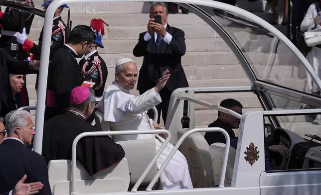 Pope Leo XIV leaves after meeting with the local Catholic community inside Monaco Cathedral in Monaco-Ville, Monaco, Saturday, March 28, 2026. (AP Photo/Laurent Cipriani)