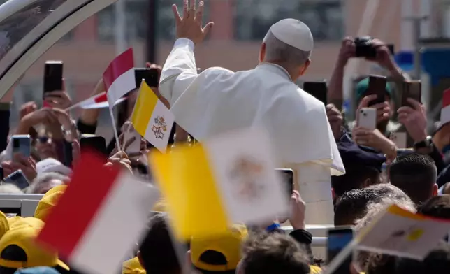 Pope Leo XIV arrives to meet with a group of young people and catechumens outside Sainte Dévote Church in La Condamine, Monaco, Saturday, March 28, 2026. (AP Photo/Gregorio Borgia)