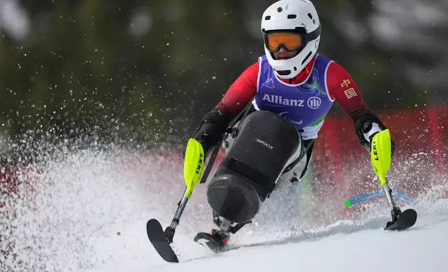 Zhang Wenjing, of China, competes in her first run of the alpine skiing women's giant slalom sitting at the 2026 Winter Paralympics, in Cortina d'Ampezzo, Italy, Saturday, March 14, 2026. (AP Photo/Evgeniy Maloletka)