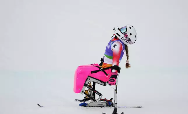 Audrey Pascual Seco, of Spain, reacts after crossing the finish line in the to win the bronze medal in the alpine skiing women's giant slalom sitting at the 2026 Winter Paralympics, in Cortina d'Ampezzo, Italy, Saturday, March 14, 2026. (AP Photo/Evgeniy Maloletka)