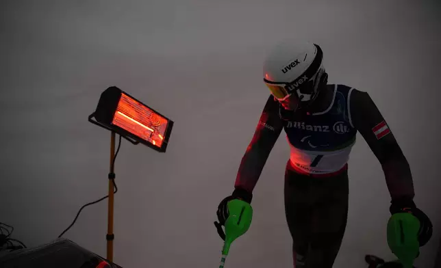 Johannes Aigner, of Austria, waits his turn to start his first run of the alpine skiing men's slalom vision impaired at the 2026 Winter Paralympics, in Cortina d'Ampezzo, Italy, Sunday, March 15, 2026. (AP Photo/Emilio Morenatti)