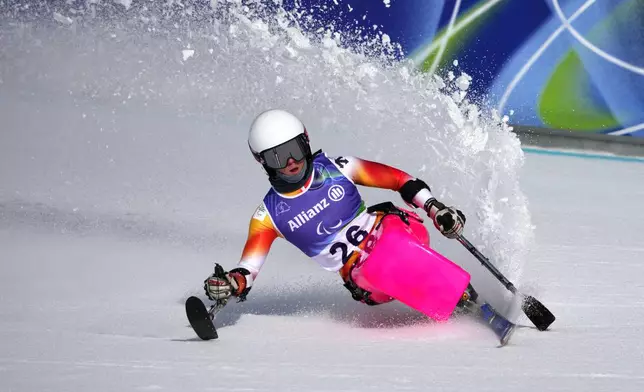 Audrey Pascual Seco, of Spain, crosses the finish line in the alpine skiing women's super-G sitting final at the 2026 Winter Paralympics, in Cortina d'Ampezzo, Italy, Monday, March 9, 2026. (AP Photo/Emilio Morenatti)
