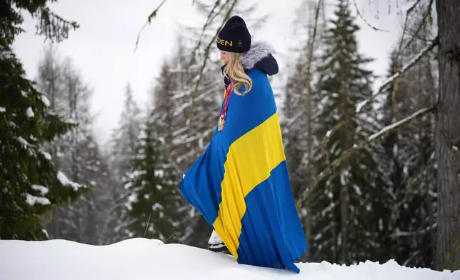 Ebba Aarsjoe, of Sweden, poses for photos with her alpine skiing three gold and one bronze medals, at the 2026 Winter Paralympics, in Cortina d'Ampezzo, Italy, Sunday, March 15, 2026. (AP Photo/Emilio Morenatti)