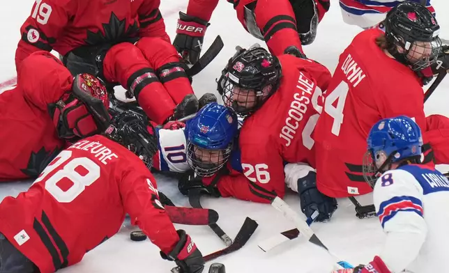 United States' Brett Bolton, center, challenges for the puck with Canada's Anton Jacobs-Webb during the ice hockey gold medal match between United States and Canada at the 2026 Winter Paralympics, in Milan, Italy, Sunday, March 15, 2026. (AP Photo/Antonio Calanni)