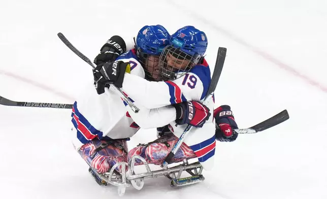 United States' Kayden Beasley, left, celebrates with his teammate Malik Jones after scoring during the ice hockey gold medal match between United States and Canada at the 2026 Winter Paralympics, in Milan, Italy, Sunday, March 15, 2026. (AP Photo/Antonio Calanni)
