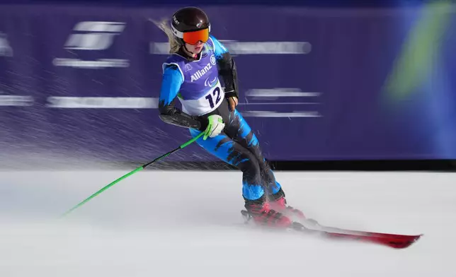 Varvara Voronchikhina, of Russia, crosses the finish line in the alpine skiing women's super-G standing final at the 2026 Winter Paralympics, in Cortina d'Ampezzo, Italy, Monday, March 9, 2026. (AP Photo/Emilio Morenatti)