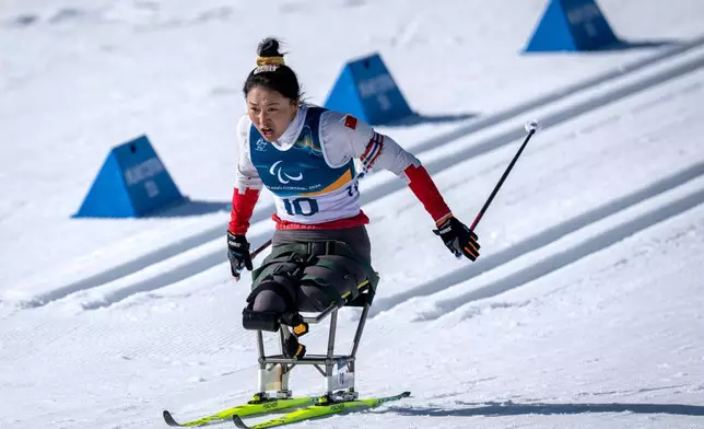 China's Shiyu Wang competes in the Para Biathlon Women's sprint sitting at the 2026 Winter Paralympics, in Tesero, Italy, Saturday, March 7, 2026. (AP Photo/Kirsty Wigglesworth)