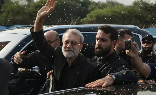 FILE - Ali Larijani, center, head of Iran's National Security Council, gestures as Hezbollah supporters throw rice to welcome him outside Rafik Hariri International Airport in Beirut, Lebanon, Wednesday, Aug. 13, 2025. (AP Photo/Bilal Hussein, File)