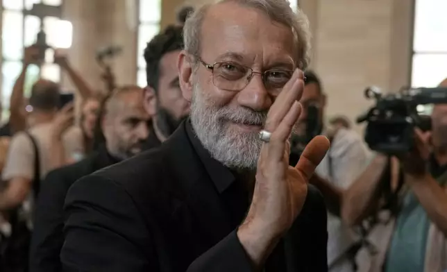 FILE - Iranian Secretary of Supreme National Security Council Ali Larijani, greets journalists upon his arrival to meet with the Lebanese parliament speaker Nabih Berri, in Beirut, Lebanon, Wednesday, Aug. 13, 2025. (AP Photo/Bilal Hussein, File)