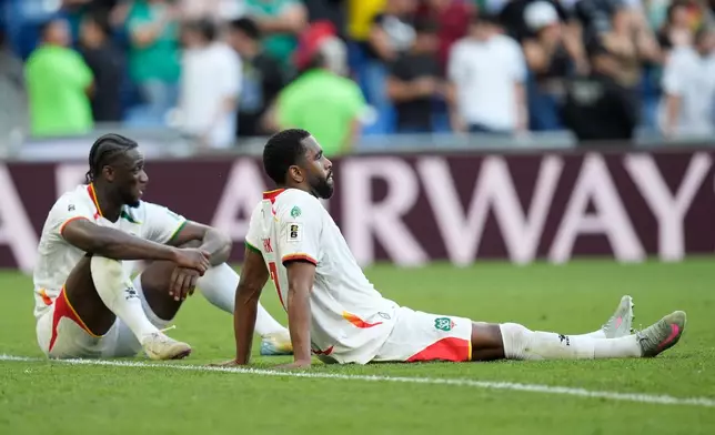 Suriname's Myenty Abena, left, and Gyrano Kerk reacts at the end of a World Cup playoff semifinal soccer match between Bolivia and Suriname in Monterrey, Mexico, Thursday, March 26, 2026. (AP Photo/Fernando Llano)