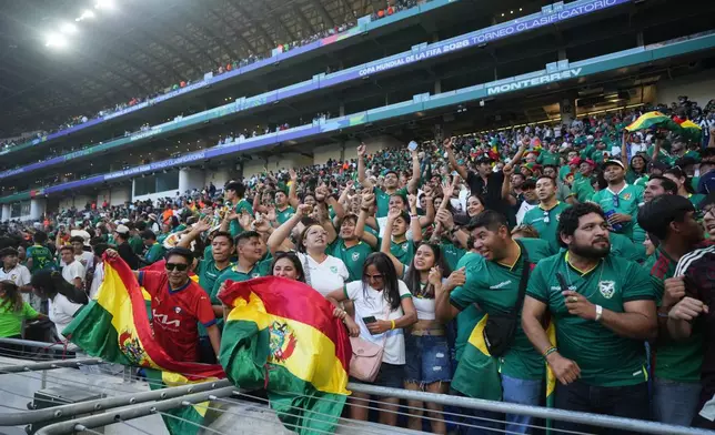 Bolivia fans celebrate after a World Cup playoff semifinal soccer match between Bolivia and Suriname in Monterrey, Mexico, Thursday, March 26, 2026. (AP Photo/Fernando Llano)