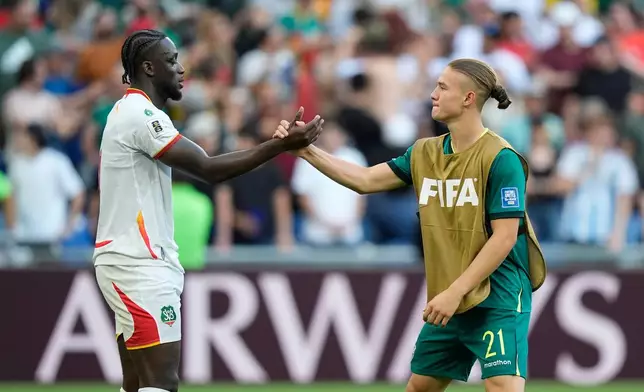 Suriname's Myenty Abena, left, and Bolivia's Lucas Macazaga shake hands after a World Cup playoff semifinal soccer match between Bolivia and Suriname in Monterrey, Mexico, Thursday, March 26, 2026. (AP Photo/Fernando Llano)