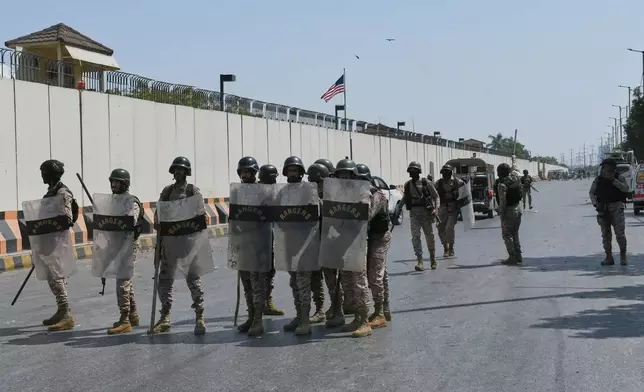 Paramilitary soldiers take positions at the U.S. Consulate after protesters stormed the building in Karachi, Pakistan, Sunday, March 1, 2026. (AP Photo/Ali Raza)