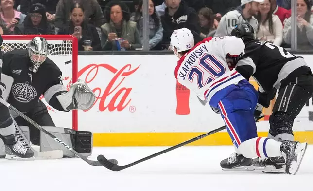 Montréal Canadiens left wing Juraj Slafkovsky, center, scores on Los Angeles Kings goaltender Darcy Kuemper during the second period of an NHL hockey game Saturday, March 7, 2026, in Los Angeles. (AP Photo/Mark J. Terrill)