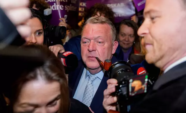 Foreign Minister Lars Løkke Rasmussen, center, leader of the Moderates, arrives at the party's election party for the 2026 Parliamentary Election at Pakhus 11, in the Oesterbro area of Copenhagen, Denmark, Tuesday, March 24, 2026. (Rasmus Flindt Pedersen/Ritzau Scanpix via AP)