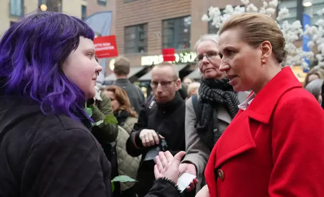 Danish Prime Minister and Leader of the Social Democrats Mette Frederiksen meets voters at a rally in her support in Copenhagen, Denmark, on Tuesday, March 24, 2026, during the general election. (AP Photo/Sergei Grits)