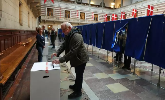 A man casts a ballot at a polling station at City Hall in Copenhagen, Denmark, on Tuesday, March 24, 2026, during the general election. (AP Photo/Sergei Grits)