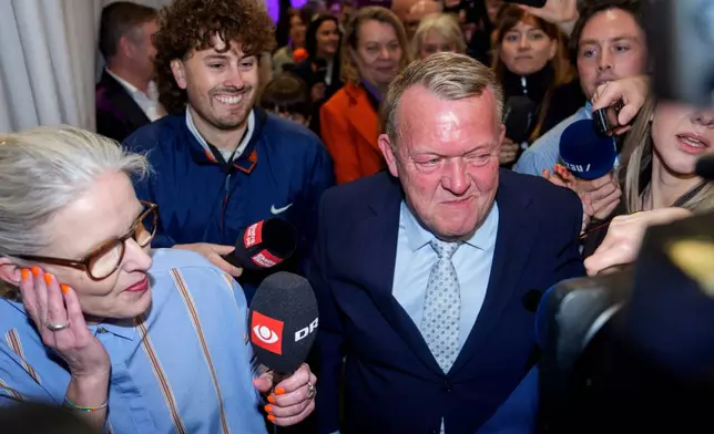 Foreign Minister Lars Løkke Rasmussen, center, leader of the Moderates, arrives at the party's election party for the 2026 Parliamentary Election at Pakhus 11, in the Oesterbro area of Copenhagen, Denmark, Tuesday, March 24, 2026. (Rasmus Flindt Pedersen/Ritzau Scanpix via AP)