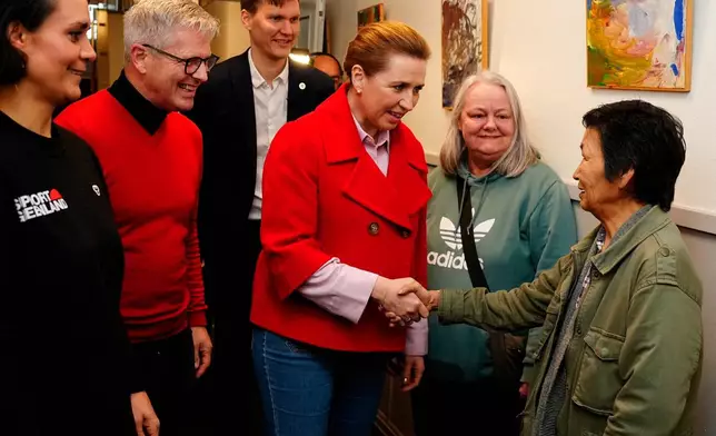 Denmark's Prime Minister and The Social Democrats' leader Mette Frederiksen meets Greenlandic voters on election day in Aalborg, Denmark, Tuesday March 24, 2026. (Henning Bagger/Ritzau Scanpix via AP)