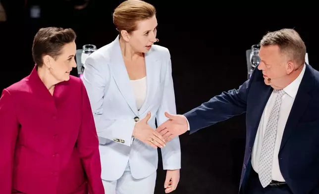 Denmark's Prime Minister Mette Frederiksen, center, Lars Loekke Rasmussen, right, and Pia Olsen Dyhr, left, attend the party leader debate Democracy's Evening on DR1 at the Concert Hall, DR City in Copenhagen, Sunday, March 22, 2026. (Mads Claus Rasmussen/Ritzau Scanpix via AP)