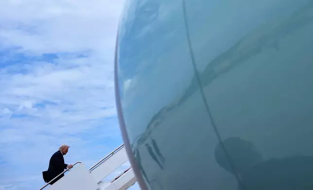 President Donald Trump boards Air Force One, Wednesday, March 11, 2026, at Joint Base Andrews, Md. (AP Photo/Julia Demaree Nikhinson)