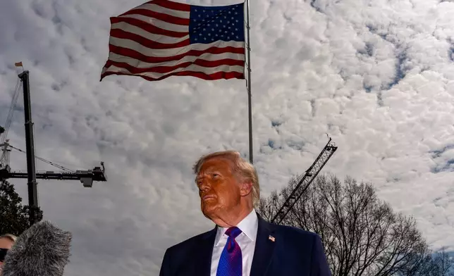 President Donald Trump speaks with reporters before departing on Marine One from the South Lawn of the White House, Wednesday, March 11, 2026, in Washington. (AP Photo/Alex Brandon)