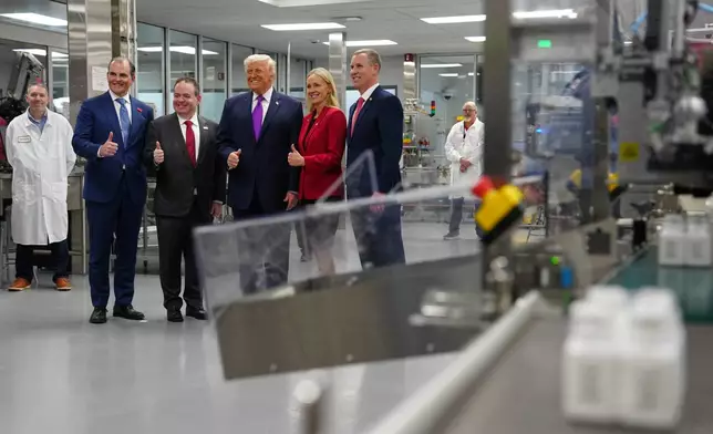 President Donald Trump poses for a photo during a visit to Thermo Fisher Scientific, Wednesday, March 11, 2026, in Cincinnati. (AP Photo/Julia Demaree Nikhinson)