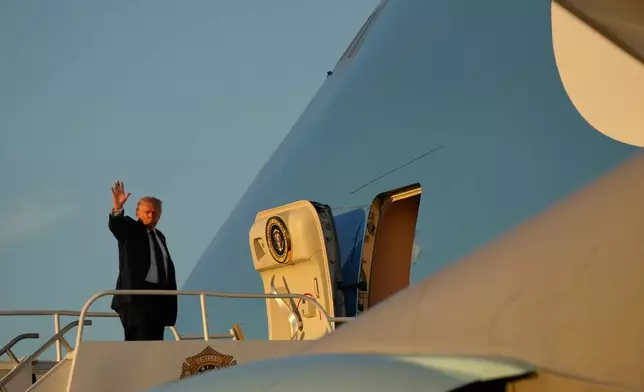 President Donald Trump waves as he boards Air Force One, Monday, March 9, 2026, at Miami International Airport in Miami. (AP Photo/Mark Schiefelbein)