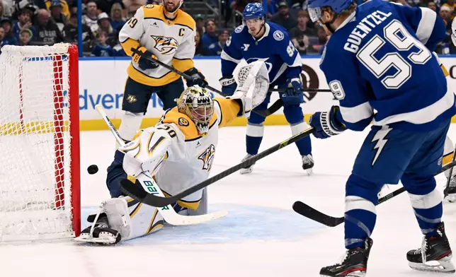 Tampa Bay Lightning center Jake Guentzel (59) scores on Nashville Predators goaltender Justus Annunen (29) during the second period of an NHL hockey game, Sunday, March 29, 2026, in Tampa, Fla. (AP Photo/Jason Behnken)