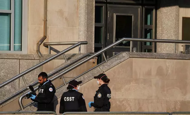 Toronto police investigate the scene after the U.S. consulate was hit by gunfire in Toronto on Tuesday March 10, 2026. (Frank Gunn/The Canadian Press via AP)