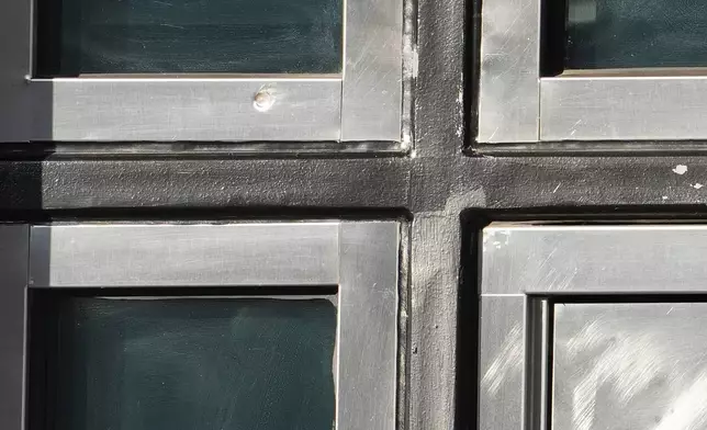 A bullet mark is shown in the door at the U.S. consulate in Toronto on Tuesday March 10, 2026. (Frank Gunn /The Canadian Press via AP)