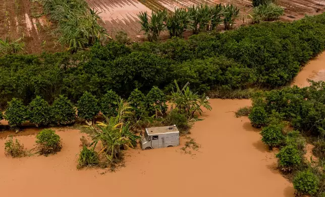 An aerial view of a truck is seen in floodwater in a field after recent storms in Mokuleia, Hawaii, Monday, March 23, 2026. (Stephen Lam/San Francisco Chronicle via AP)