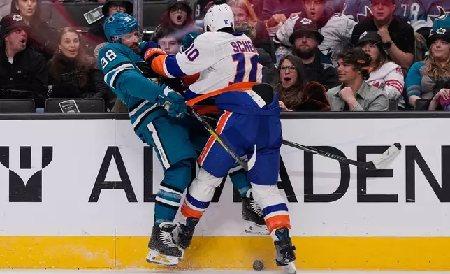 New York Islanders center Brayden Schenn (10) collides with San Jose Sharks defenseman Mario Ferraro (38) during the first period of an NHL hockey game, Saturday, March 7, 2026, in San Jose, Calif. (AP Photo/Godofredo A. Vásquez)