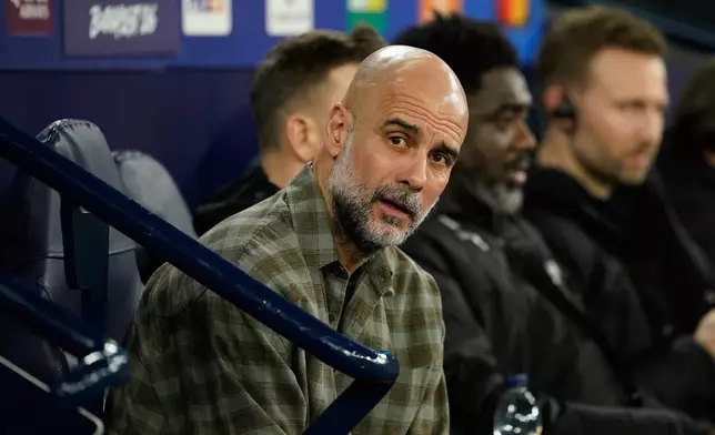 Manchester City's head coach Pep Guardiola watches from the bench ahead of the Champions League round of 16 second leg soccer match between Manchester City and Real Madrid in Manchester, Tuesday, March 17, 2026. (AP Photo/Dave Thompson)