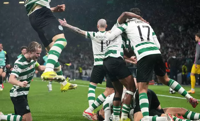 Sporting CP players celebrate after Sporting's Maximiliano Araujo scored his side's fourth goal during a Champions League round of 16 second leg soccer match between Sporting CP and Bodo Glimt in Lisbon, Portugal, Tuesday, March 17, 2026. (AP Photo/Ana Brigida)
