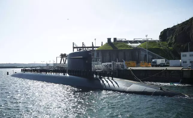 Sailors are aboard a submarine awaiting the arrival of French President Emmanuel Macron at the nuclear submarine navy base of Ile Longue in Crozon, France, Monday March 2, 2026. (Yoan Valat/Pool Photo via AP)