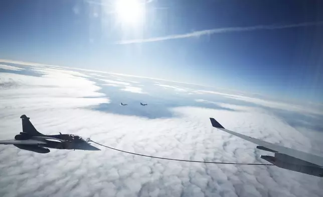 A Rafale aircraft and an MRTT refueling plane take part in a refueling operation moments before the arrival of French President Emmanuel Macron at the nuclear submarine navy base of Ile Longue in Crozon, France, Monday March 2, 2026.(Yoan Valat/Pool Photo via AP)