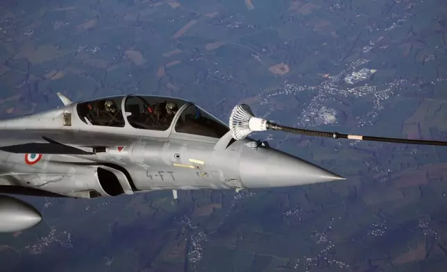 A Rafale aircraft takes part in a refueling operation moments before the arrival of French President Emmanuel Macron at the nuclear submarine navy base of Ile Longue in Crozon, France, Monday March 2, 2026.(Yoan Valat/Pool Photo via AP)