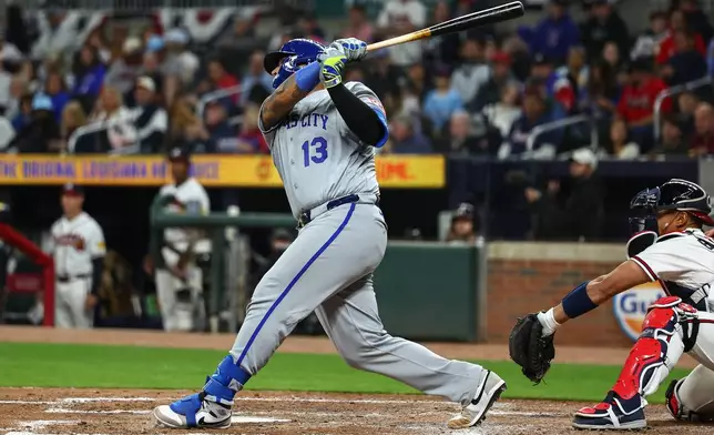 Kansas City Royals' Salvador Perez (13) hits a solo home run in the seventh inning of a baseball game against the Atlanta Braves, Saturday, March 28, 2026, in Atlanta. (AP Photo/Colin Hubbard)