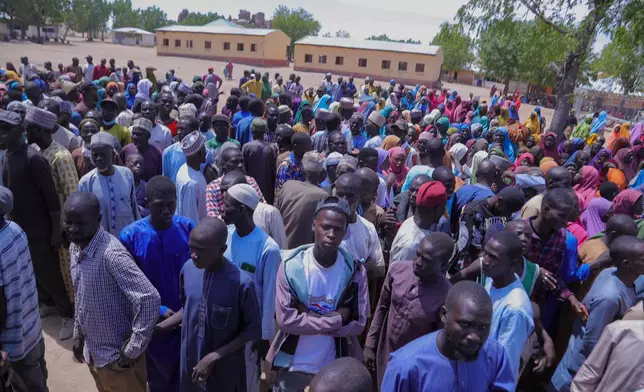 People gather for a meeting with the Borno state governor in Pulka, Nigeria, Friday, March 6, 2026, after they fled an attack by Islamic militants in Ngoshe. (AP Photo/Jossy Ola)
