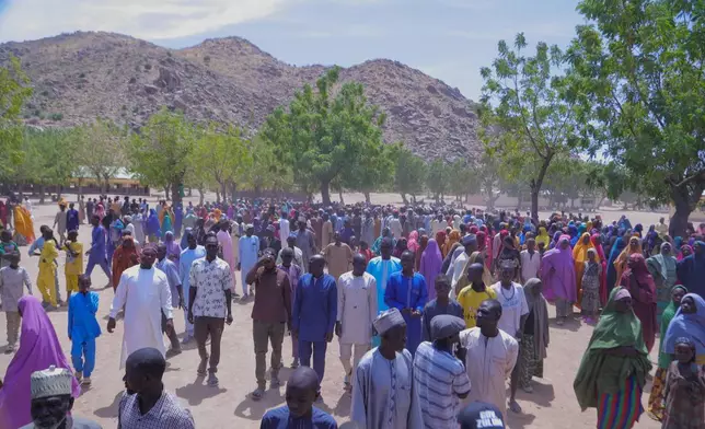 People gather for a meeting with the Borno state governor in Pulka, Nigeria, Friday, March 6, 2026, after they fled an attack by Islamic militants in Ngoshe. (AP Photo/Jossy Ola)