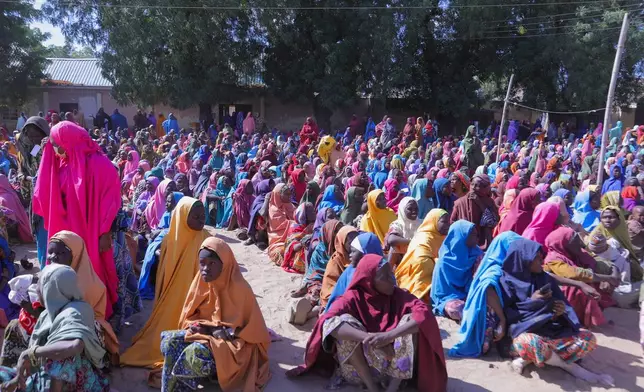 People gather in Pulka, Nigeria, Friday, March 6, 2026, after fleeing an attack by Islamic militants in Ngoshe. (AP Photo/Jossy Ola)
