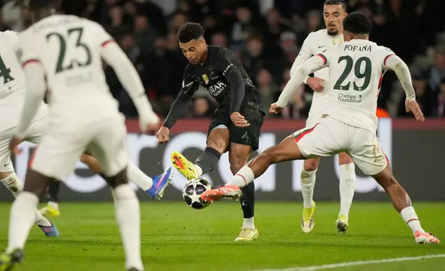Chelsea's Wesley Fofana, right, tries to block a shot from PSG's Desire Doue, center, during the first leg of the Champions League round of 16 soccer match between Paris Saint-Germain and Chelsea, in Paris, Wednesday, March 11, 2026. (AP Photo/Michel Euler)