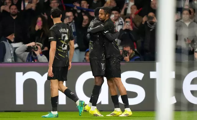 PSG's Bradley Barcola, right, celebrates with teammates after scoring the opening goal during the first leg of the Champions League round of 16 soccer match between Paris Saint-Germain and Chelsea, in Paris, Wednesday, March 11, 2026. (AP Photo/Michel Euler)