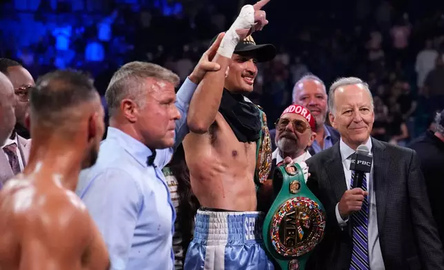 Sebastian Fundora celebrates after defeating Keith Thurman in a super welterweight championship boxing match Saturday, March 28, 2026, in Las Vegas. (AP Photo/John Locher)