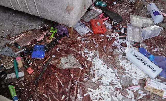Blood is seen on the floor of a beauty salon damaged in a deadly Iranian strike in the West Bank village of Beit Awa, near Hebron, Thursday, March 19, 2026. (AP Photo/Mahmoud Illean)