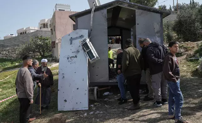 Palestinians inspect the damage at a beauty salon after a deadly Iranian strike in the West Bank village of Beit Awa, near Hebron, Thursday, March 19, 2026. (AP Photo/Mahmoud Illean)