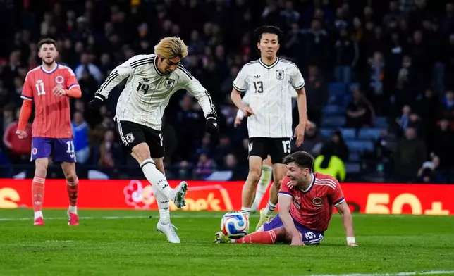 Japan's Junya Ito scores the opening goal during the international friendly soccer match against Scotland, in Glasgow, Scotland, Saturday March 28, 2026. (Andrew Milligan/PA via AP)